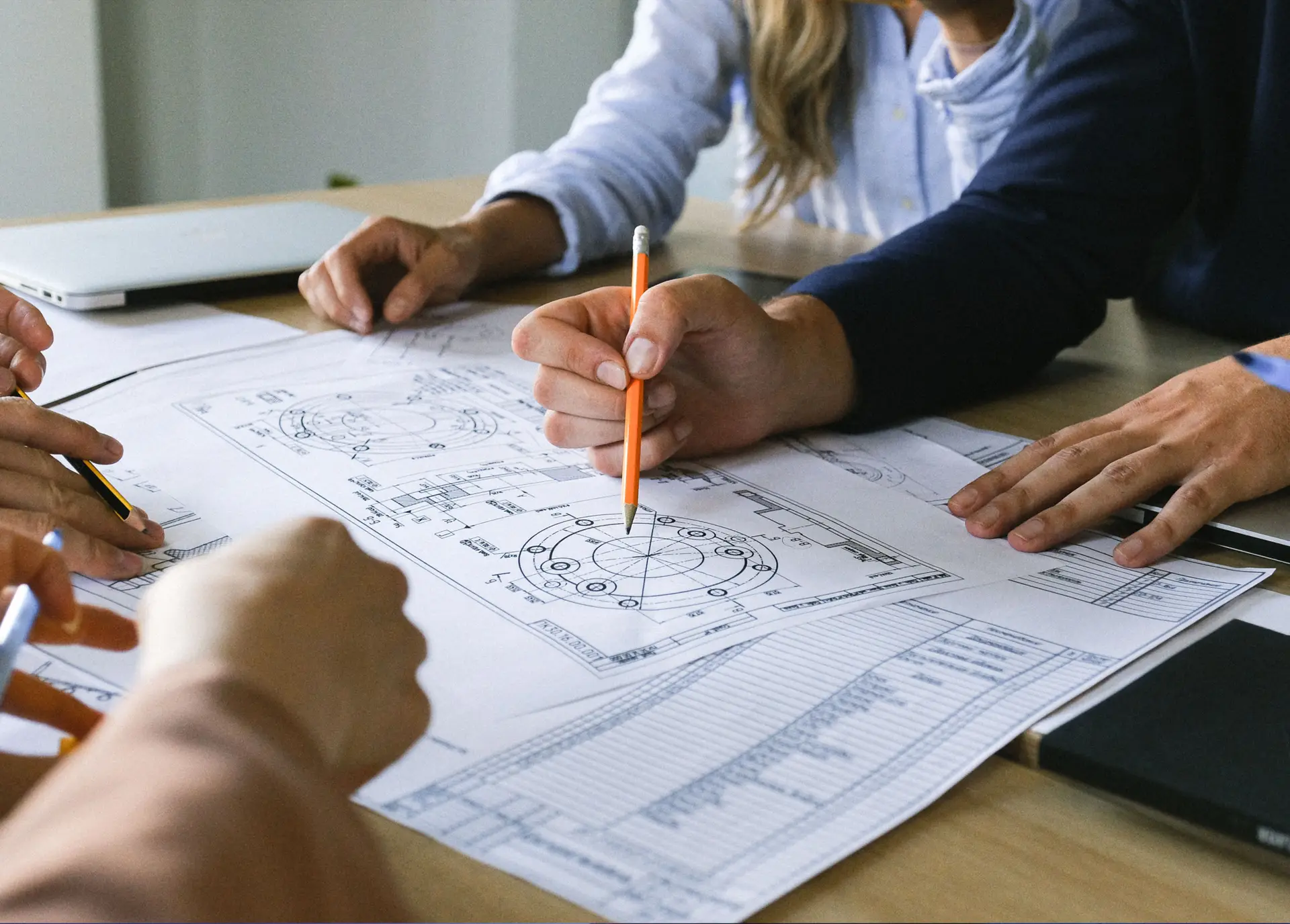 Engineers reviewing architectural drawings during design validation